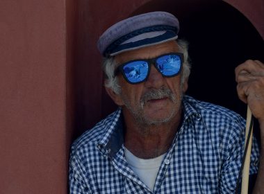 Elderly European man standing in a doorway