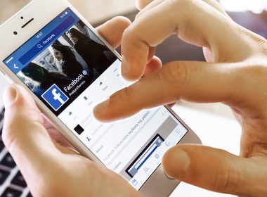 Man uses social media on his phone