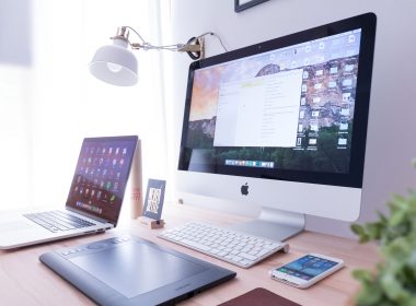 Computer, laptop and mobile phone on a desk