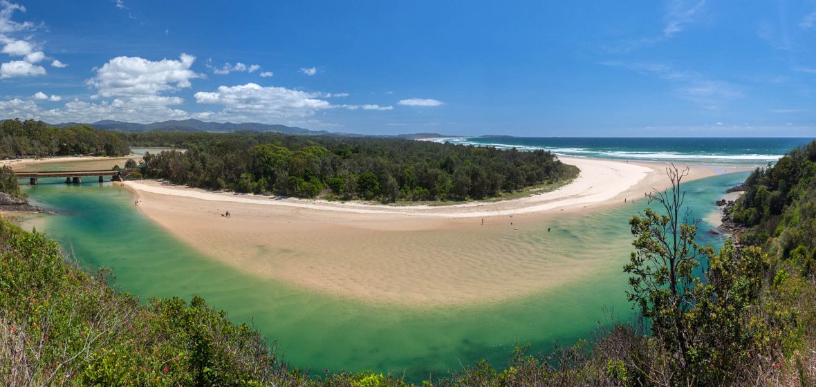 Small sand-bar island connected to mainland by bridge