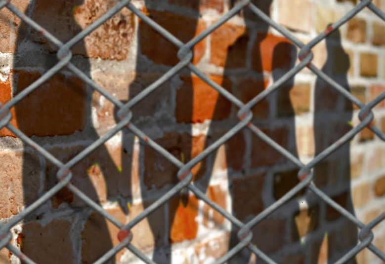 Chain-link fence outside a prison exercise yard