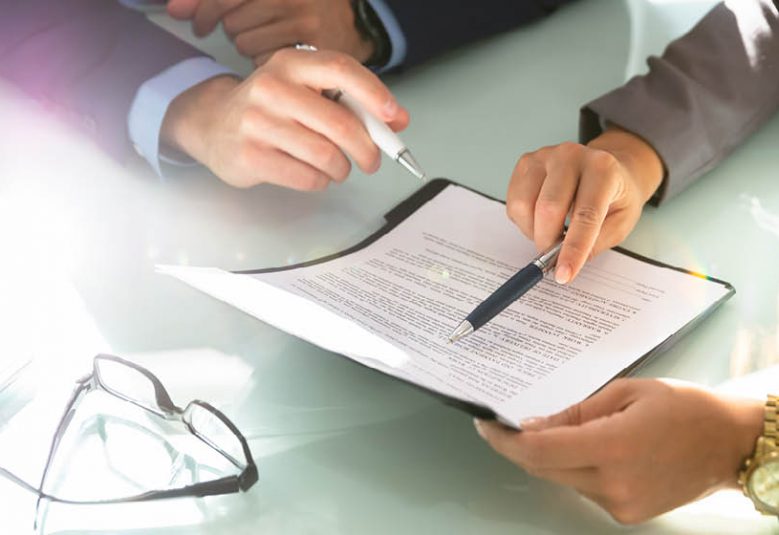 Two people reviewing a document