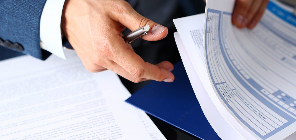 Man organises a stack of forms