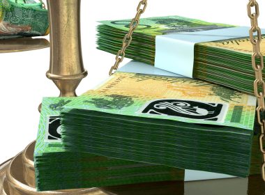 Stacks of Australian $100 notes on a scale