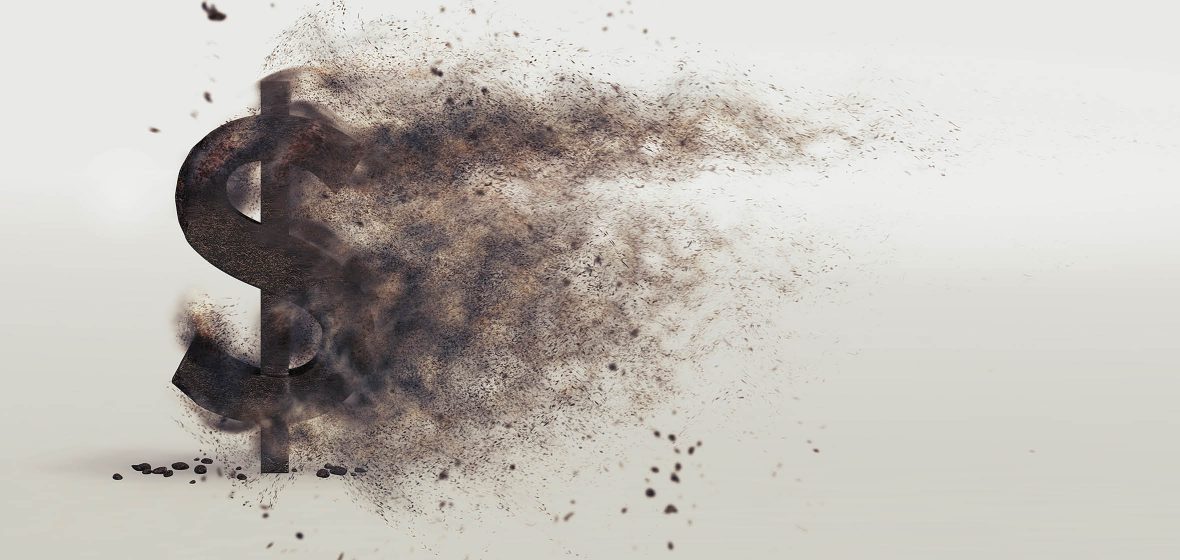 Black dollar sign that has been burnt and is disintergrating