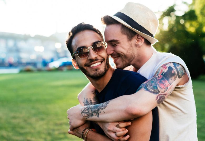 Two men hugging in a park