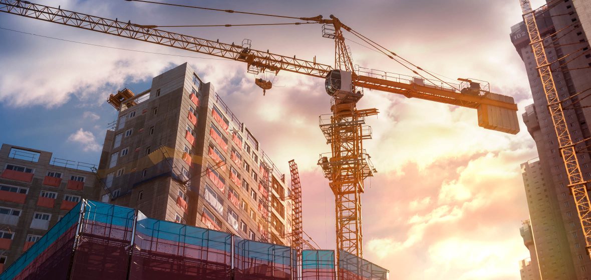 Crane next to apartment building under construction