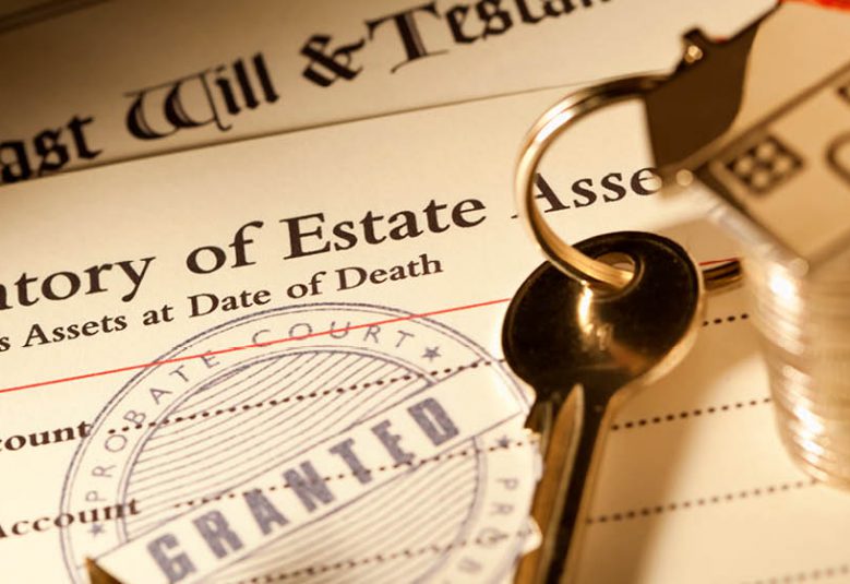 Stack of probate and will documents on a desk with a set of keys and coins