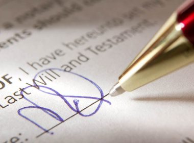 Close up of pen signing a will