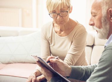 Solicitor reviews document with older female client