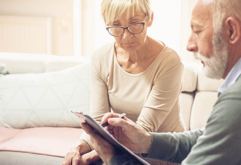 Solicitor reviews document with older female client
