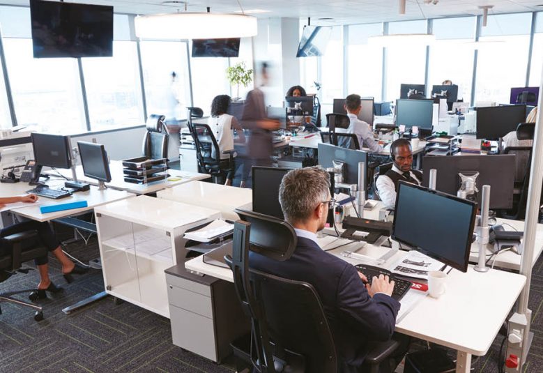 open plan office with staff working at computer