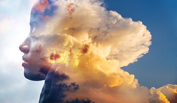 A woman's face superimposed over sky and clouds