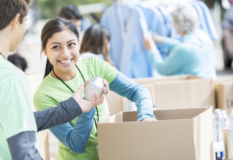 Volunteers pack cartons.