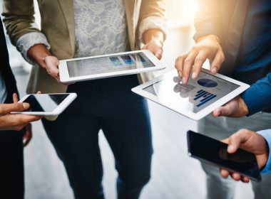 Businesspeople using their wireless devices outside
