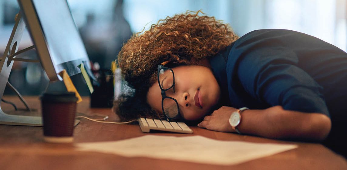 woman sleeping at desk