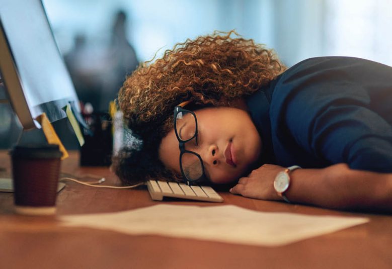 woman sleeping at desk