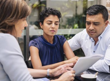 Professional discussing document with couple