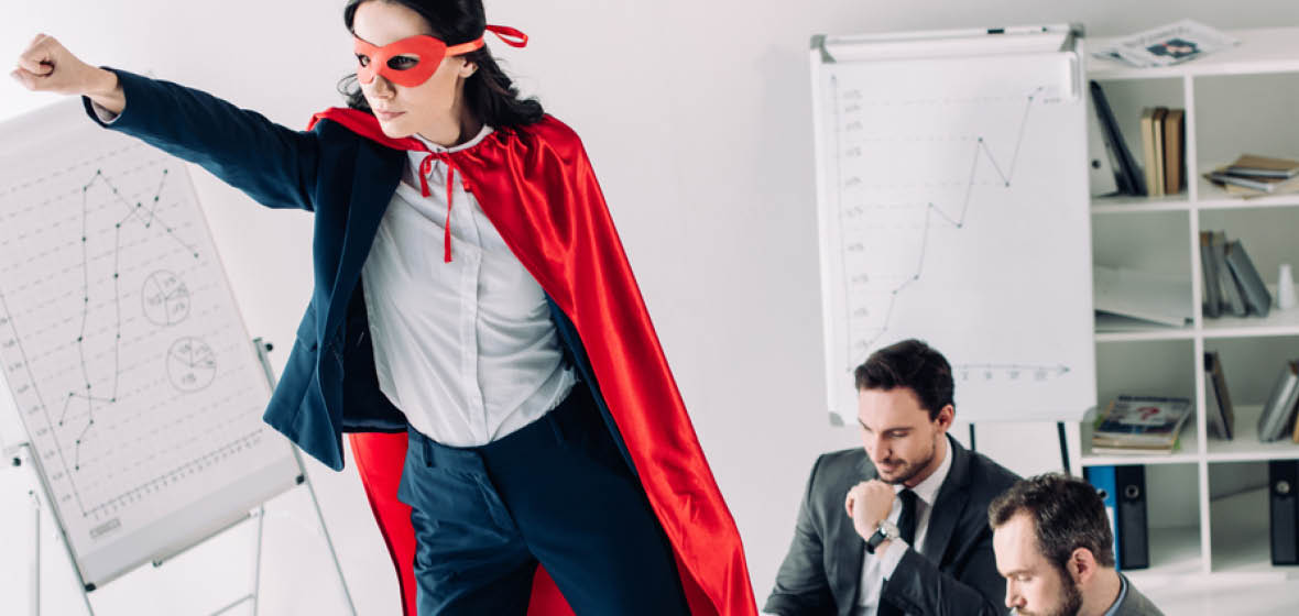 Woman in superhero cap in office