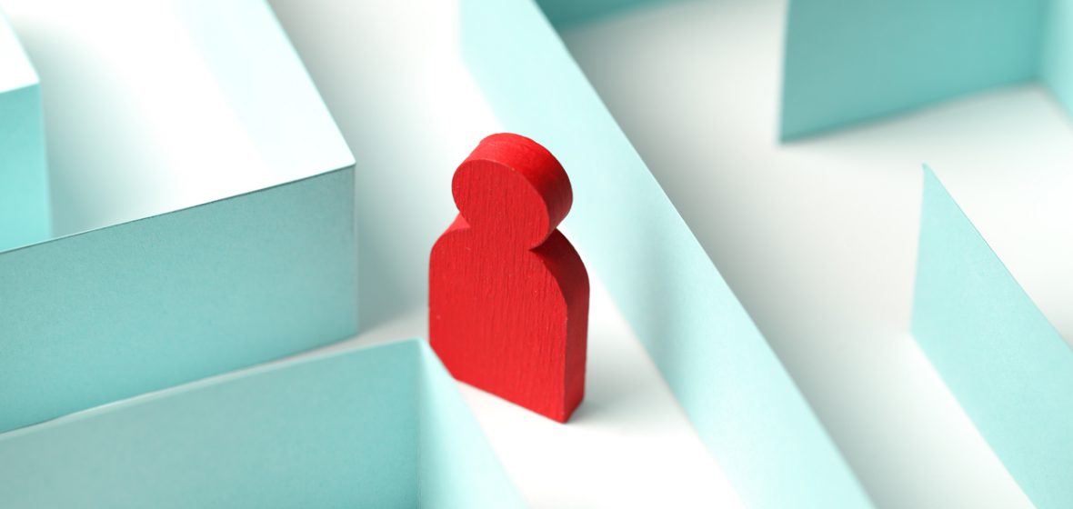The figure of a person is looking for a way out of the maze,