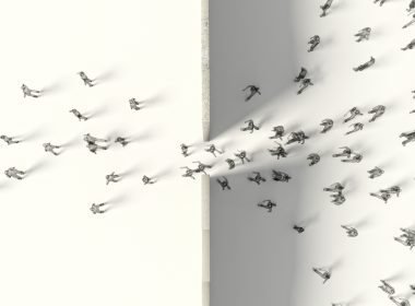 aerial view of people walking through a gap in a dividing wall