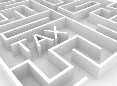 A wooden maze with the word 'Tax' at the centre