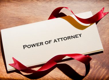 Power of Attorney document with red ribbon