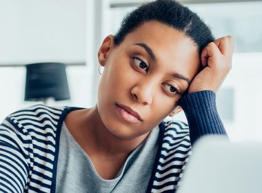 Tired woman looks at her computer