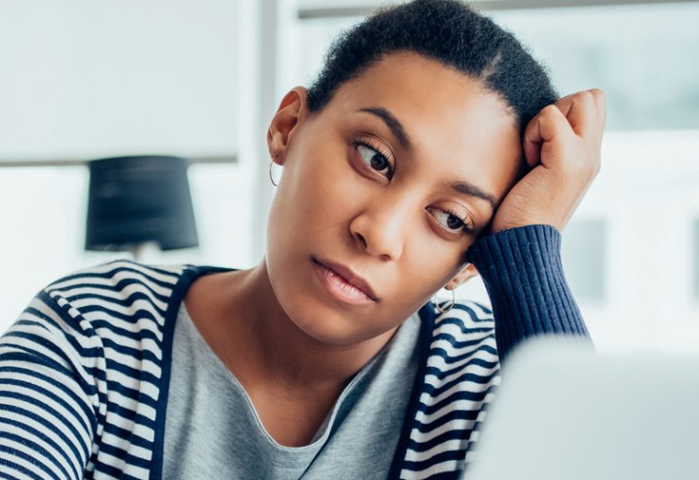 Tired woman looks at her computer