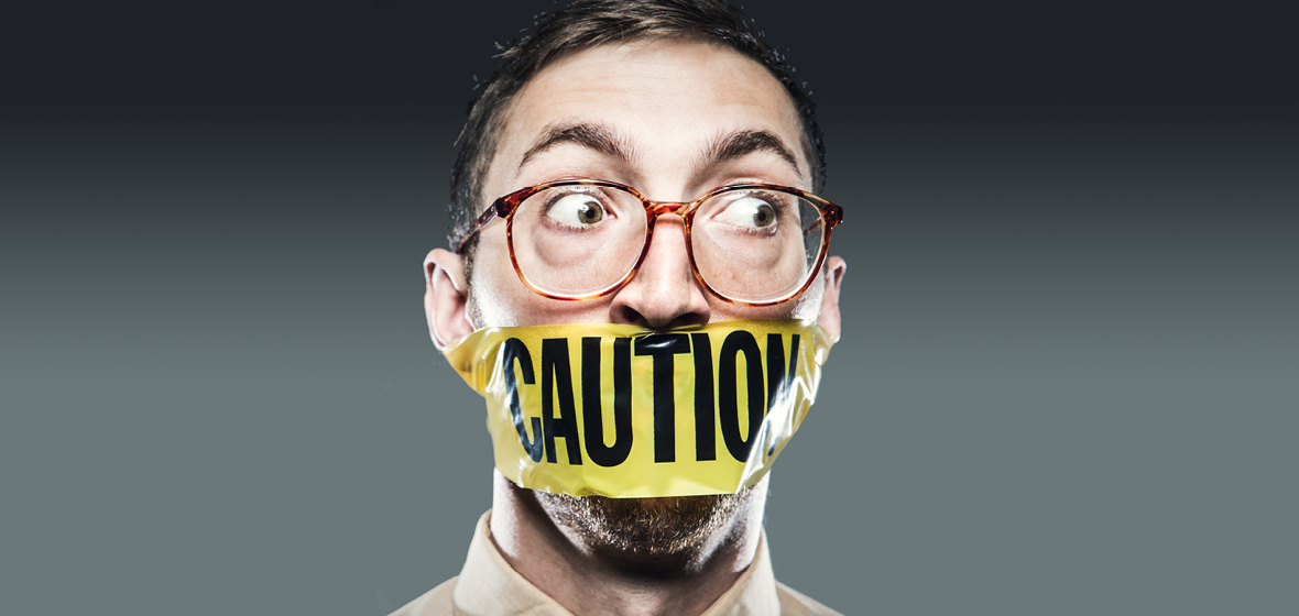 Man with caution tape on mouth