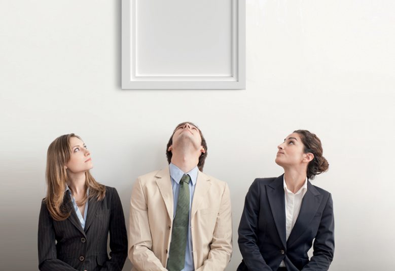 Three people looking up at an empty picture frame