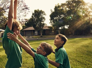 Two brothers play in a backyard
