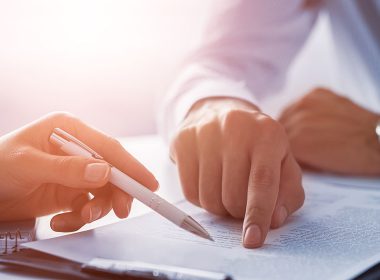 Two men review a document