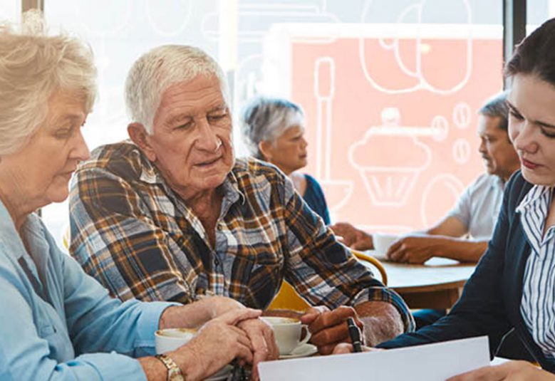 Solicitor reviews a document with an older couple