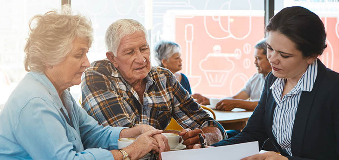 Solicitor reviews a document with an older couple