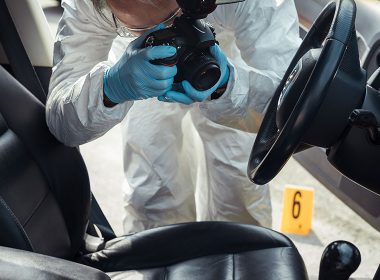 Police officer photographs interior of a car