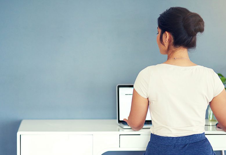 Woman sits at a desk typing