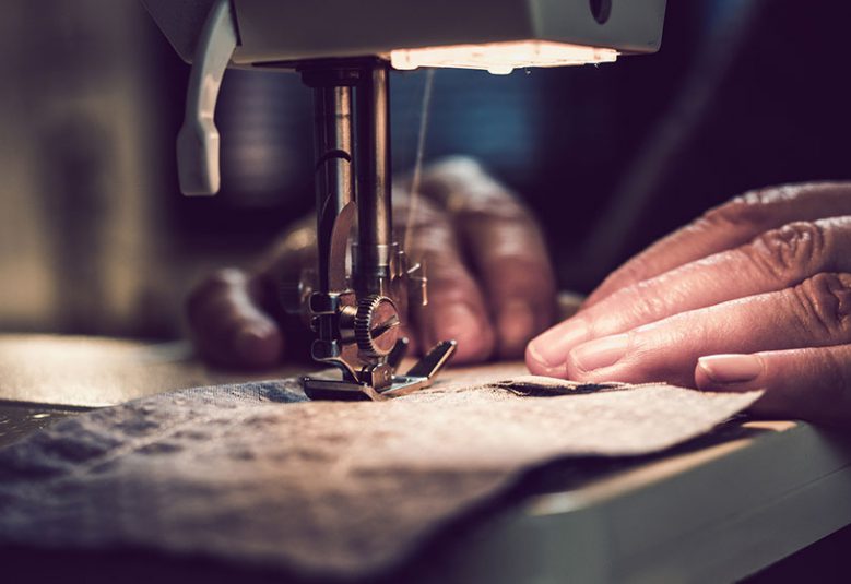 Vulnerable worker uses a sewing machine