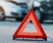 Traffic cone in front of two cars after an accident