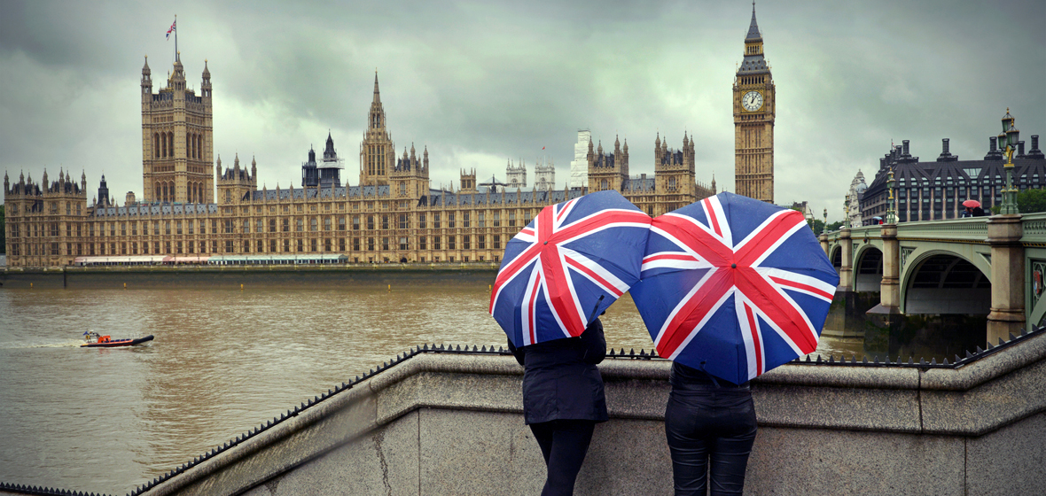 Tourists looking at Big Ben across the river.