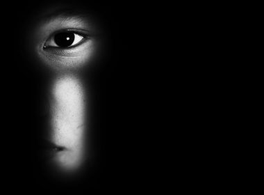 Child looking through a keyhole