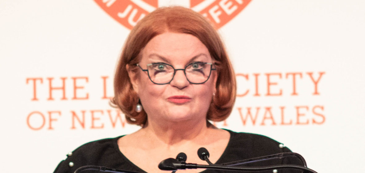 President of the Law Society of NSW Juliana Warner speaking in front of a lectern.