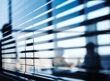 people behind blinds in an office