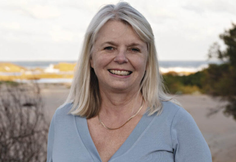 photo of lawyer Anita Cains with the sea in the bakcground