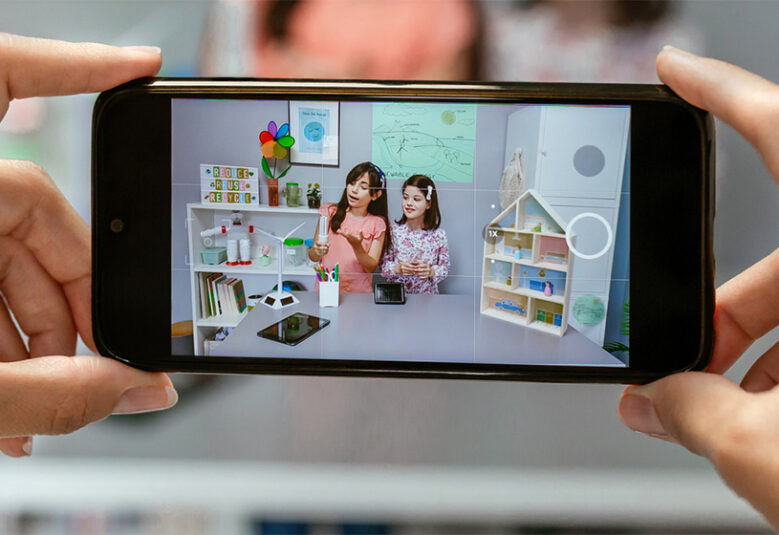 photo of hands holding phone showing child influencers
