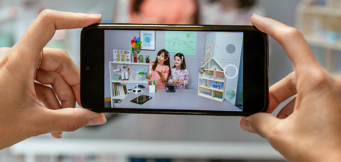 photo of hands holding phone showing child influencers
